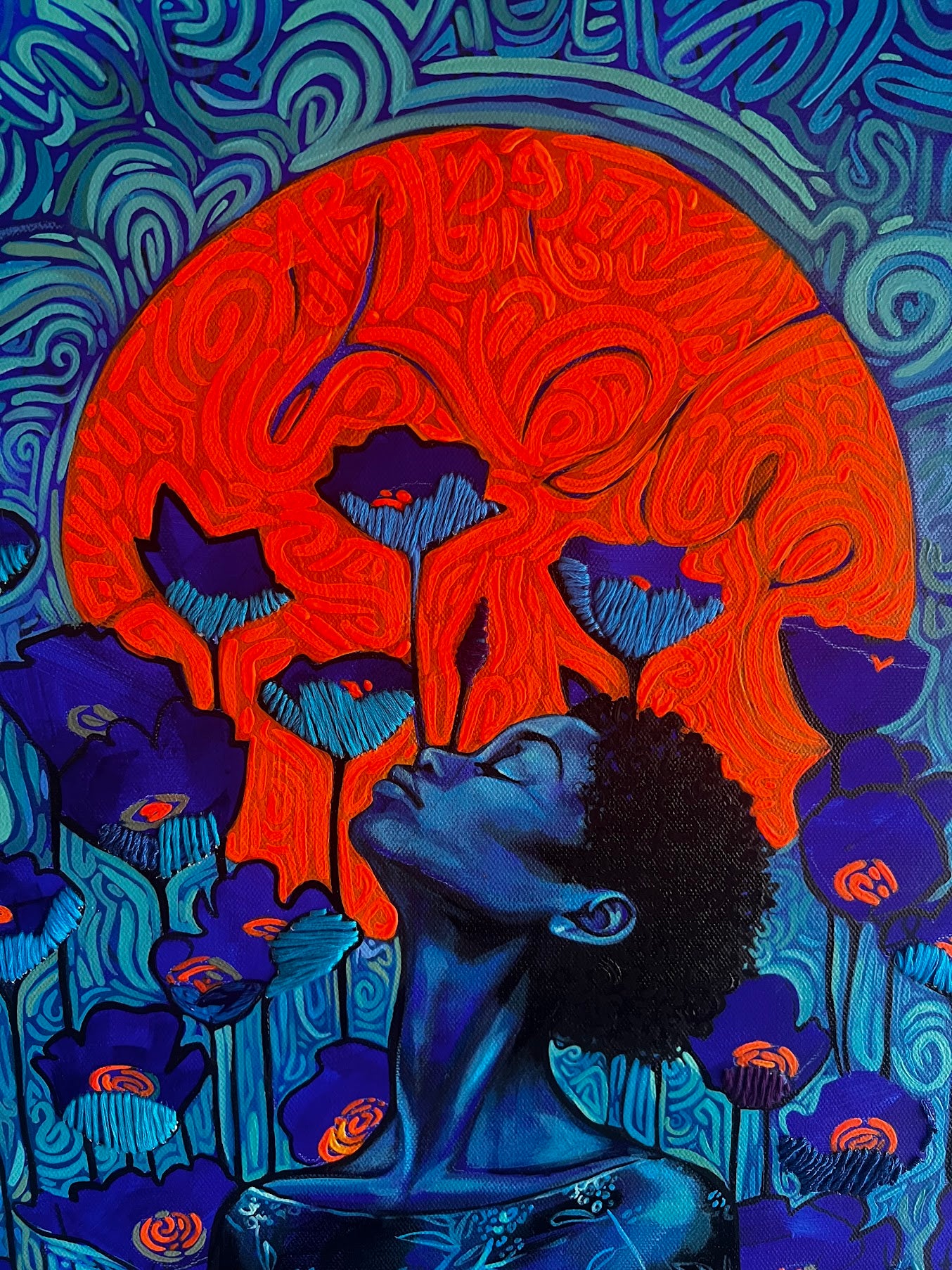 Artistic depiction of a person sitting under an orange moon with blue floral elements